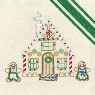 Decorative gingerbread house with candy cane and gingerbread men on a striped background