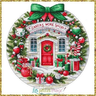 Decorative image of Santa's Workshop with Christmas elements and 'Les Petites Croix' branding.
