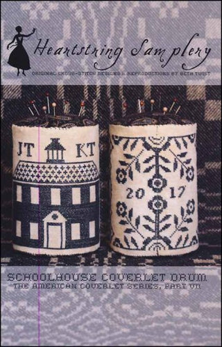 Pin drum cross stitch featuring a schoolhouse and coverlet-inspired patterns in traditional colors, Schoolhouse Coverlet Pin Drum by Heartstring Samplery.