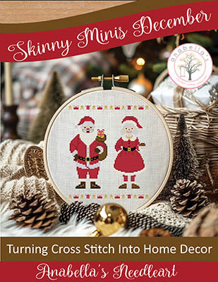 Cross-stitched design of Santa and Mrs. Claus in a hoop, surrounded by Christmas decor.