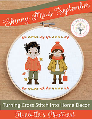 Cross-stitched design of two people in autumn clothing with 'Anabella's Needleart' branding.