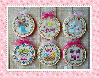 Six spring-themed mini cross stitch rounds by Waxing Moon Designs featuring flowers, a bunny, house, basket, and “Hello Spring” design.