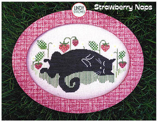 Cross Stitch pattern with a black cat design on a pink fabric background