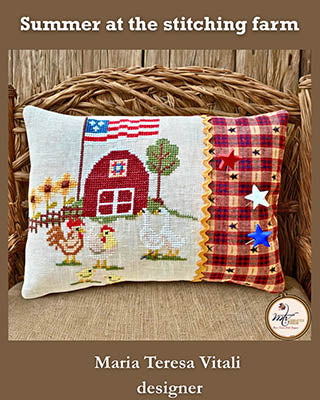 Decorative pillow with cross-stitched design and plaid border on a wooden surface, featuring 'Summer at the stitching farm' text.
