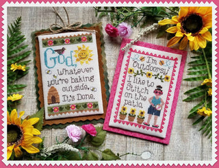 Two cross-stitched pieces with floral designs and text, surrounded by sunflowers and flowers on a textured fabric background.