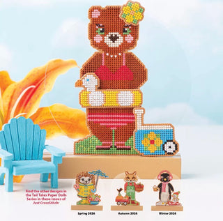 Cross-stitched bear design with additional characters on a light blue background