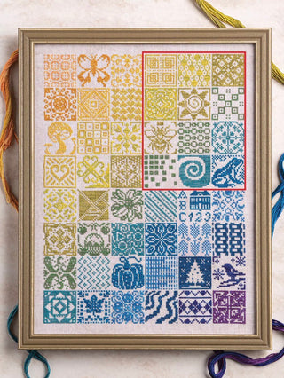 Framed cross-stitch pattern with colorful geometric and nature-themed designs.