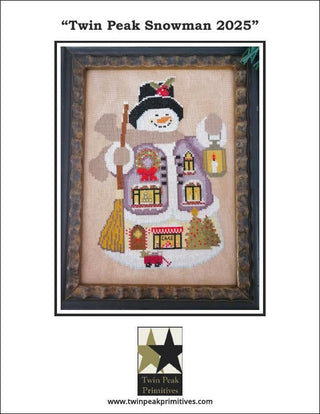 Framed cross-stitched snowman with decorative elements on a white background, featuring Twin Peak Primitives branding.