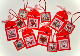 Red Valentine's Day gift tags with printed designs on a white background