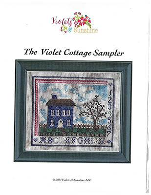 Violet Cottage Sampler pattern with a house and tree design on a white background.