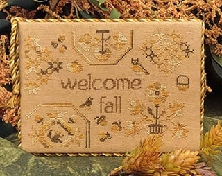 Fall-themed Quaker-style cross stitch design with the words “Welcome Fall,” surrounded by autumn leaves, birds, acorns, pumpkin, and owl on tan background.