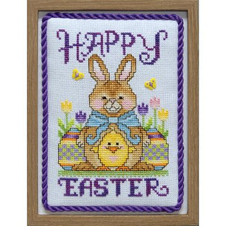 Cross-stitched Easter card with a bunny and eggs, framed in a wooden border.