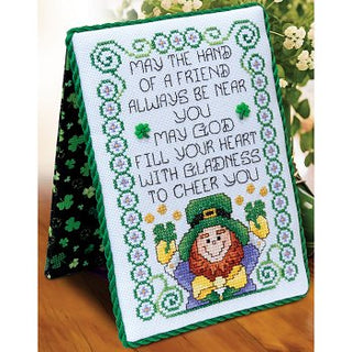 Cross-stitched design with a leprechaun and inspirational quote on a green background