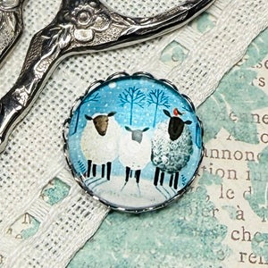Winter Sheep needle minder by My Big Toe Designs on a cross stitch fabric background