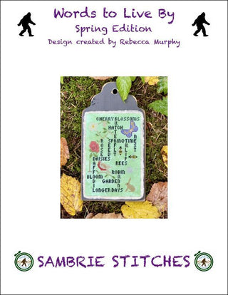 A vertical cross stitch sampler featuring spring-themed words and phrases with small motifs like flowers, birds, and a rabbit on a soft green background.