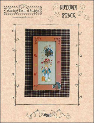 A cross stitch pattern packet for a Autumn themed design, featuring a scarecrow, apples, and pumpkins, with a plaid border.